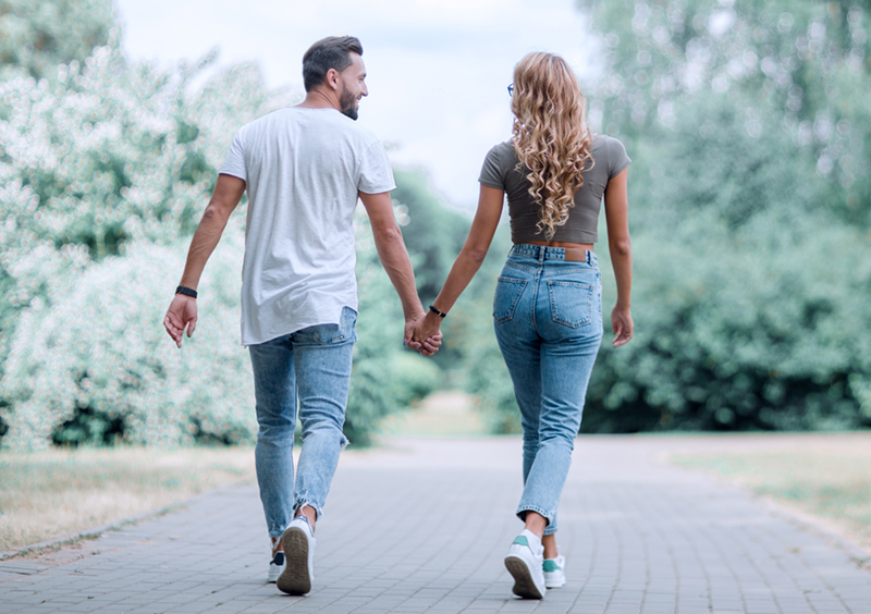 A couple walking holding hands